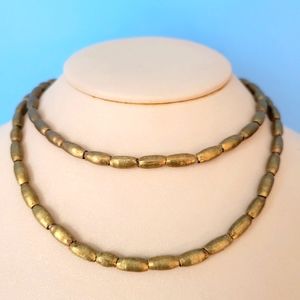 NEW unique solid metal gold coloured bead necklace.
